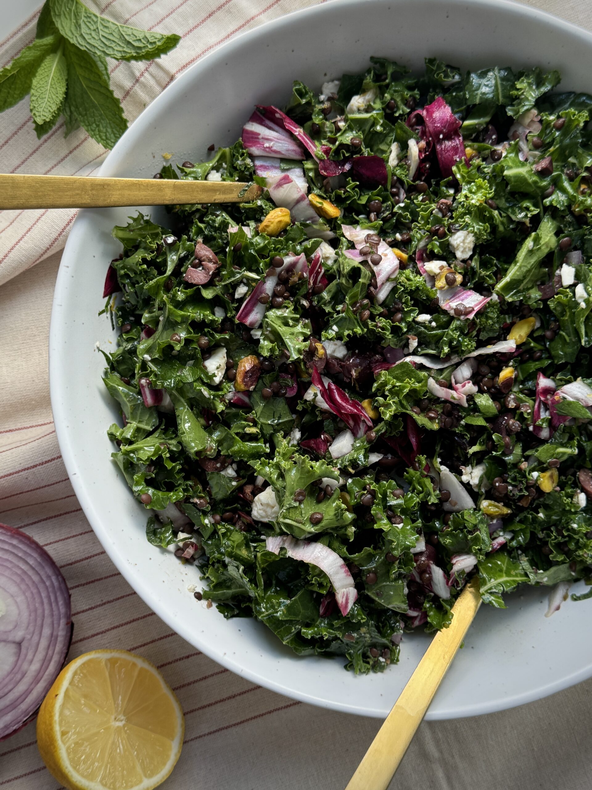 Anti-inflammatory kale salad with beluga lentils, olives, and fresh mint, perfect for meal prepping