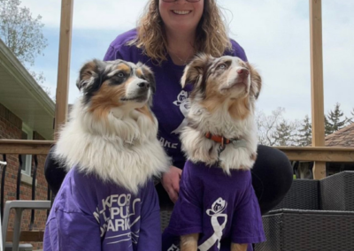 Girl and her two dogs wearing purple t-shirts in support of Lupus Awareness.