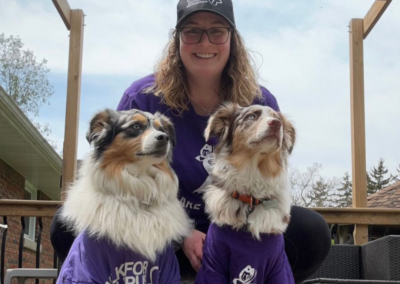 Girl and her two dogs wearing purple t-shirts in support of Lupus Awareness.