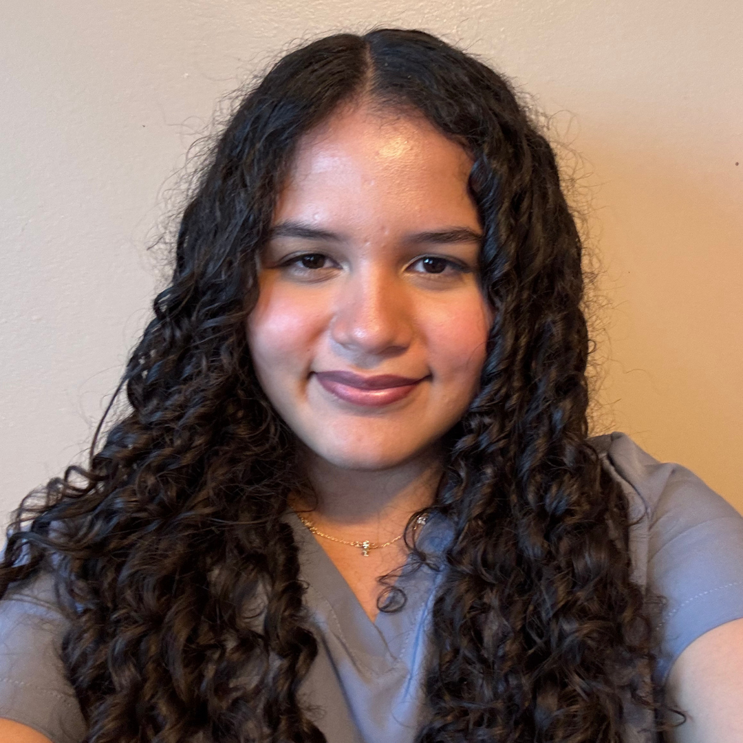 Portrait of Diana Rodriguez, Lupus Canada Scholarship Winner, with curly hair and a grey top.