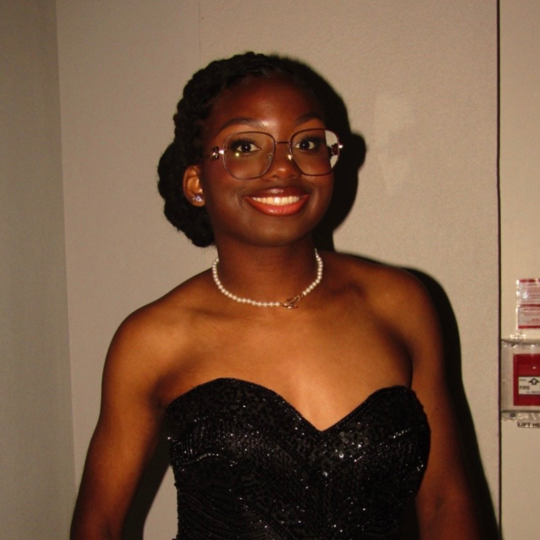 Portrait of Zerrin Hospedales, Lupus Canada Scholarship Winner, wearing a black gown and pearl necklace.
