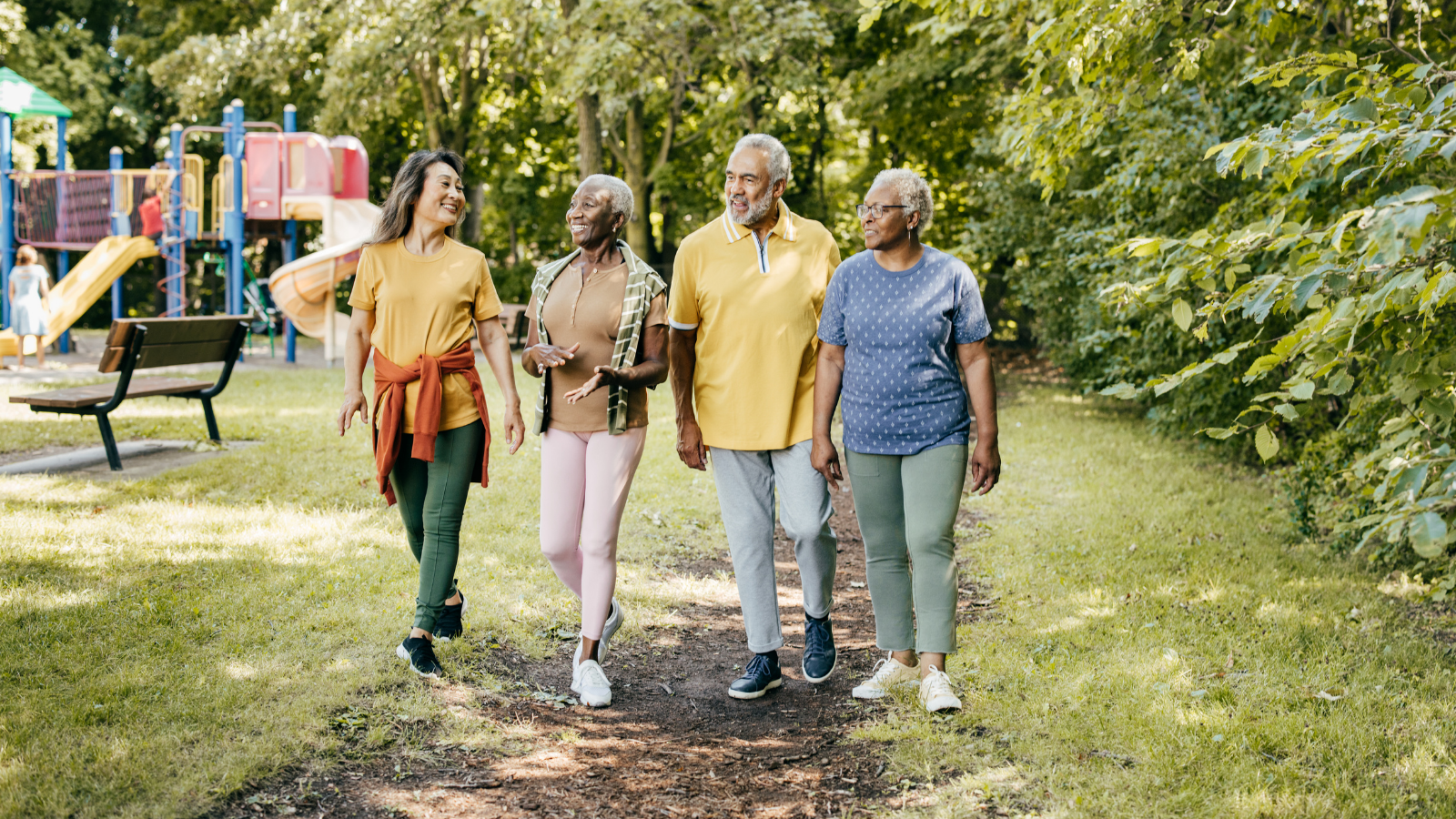 A group of older adults walking together in a park, representing community wellness and prevention for people with lupus, used on a page about COVID-19 vaccine and lupus information.