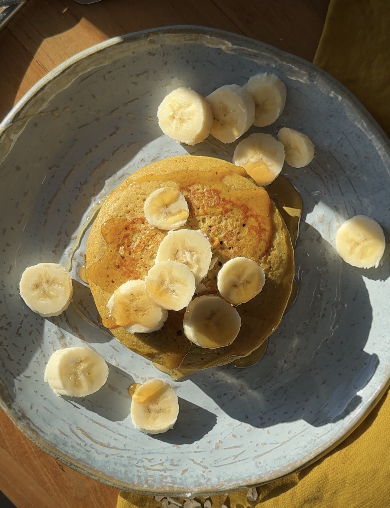 Blended oat pancakes with turmeric served warm on a plate, a nourishing breakfast option
