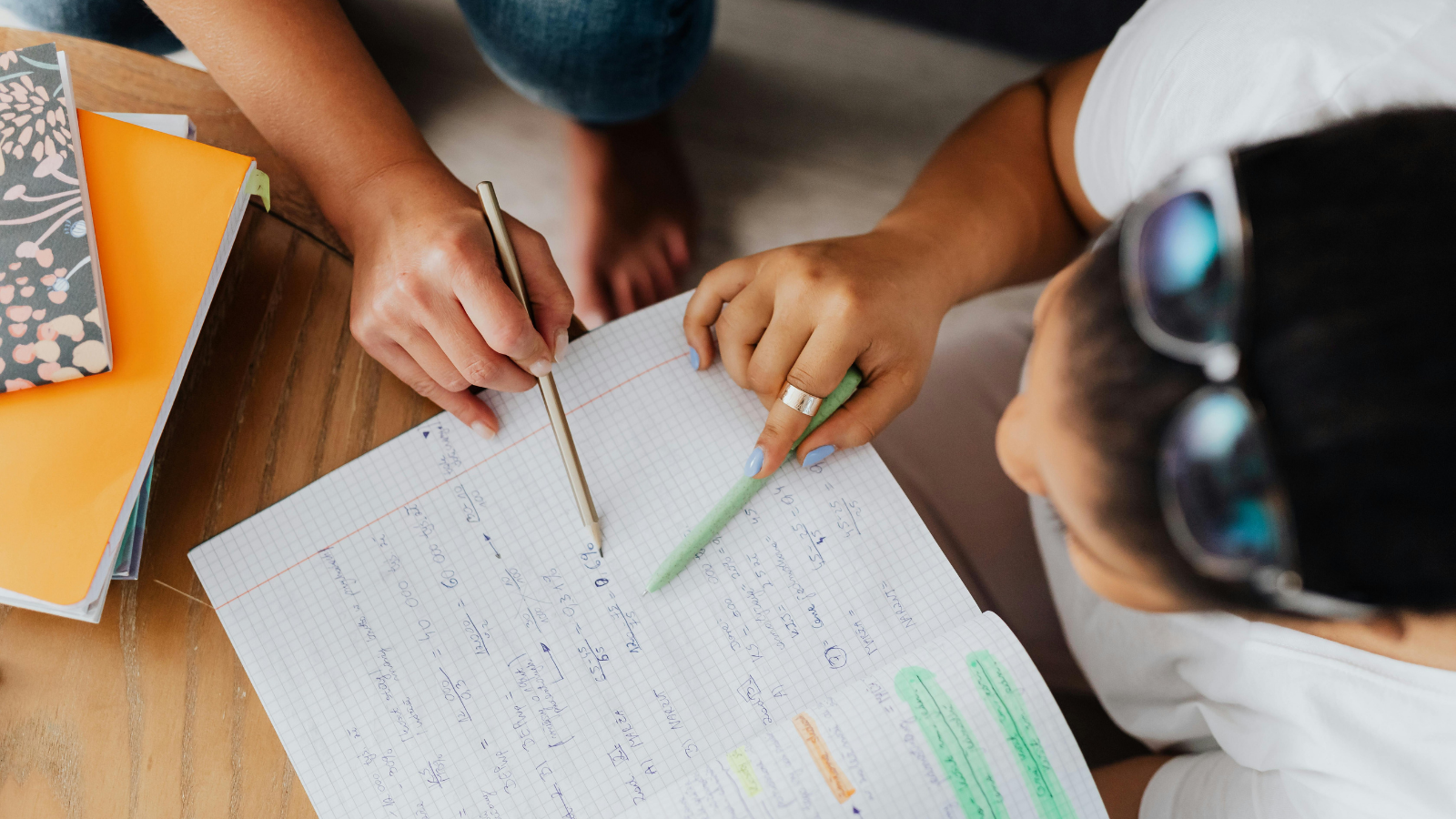 Two students reviewing schoolwork together, illustrating the importance of academic support and accommodations for students living with lupus.