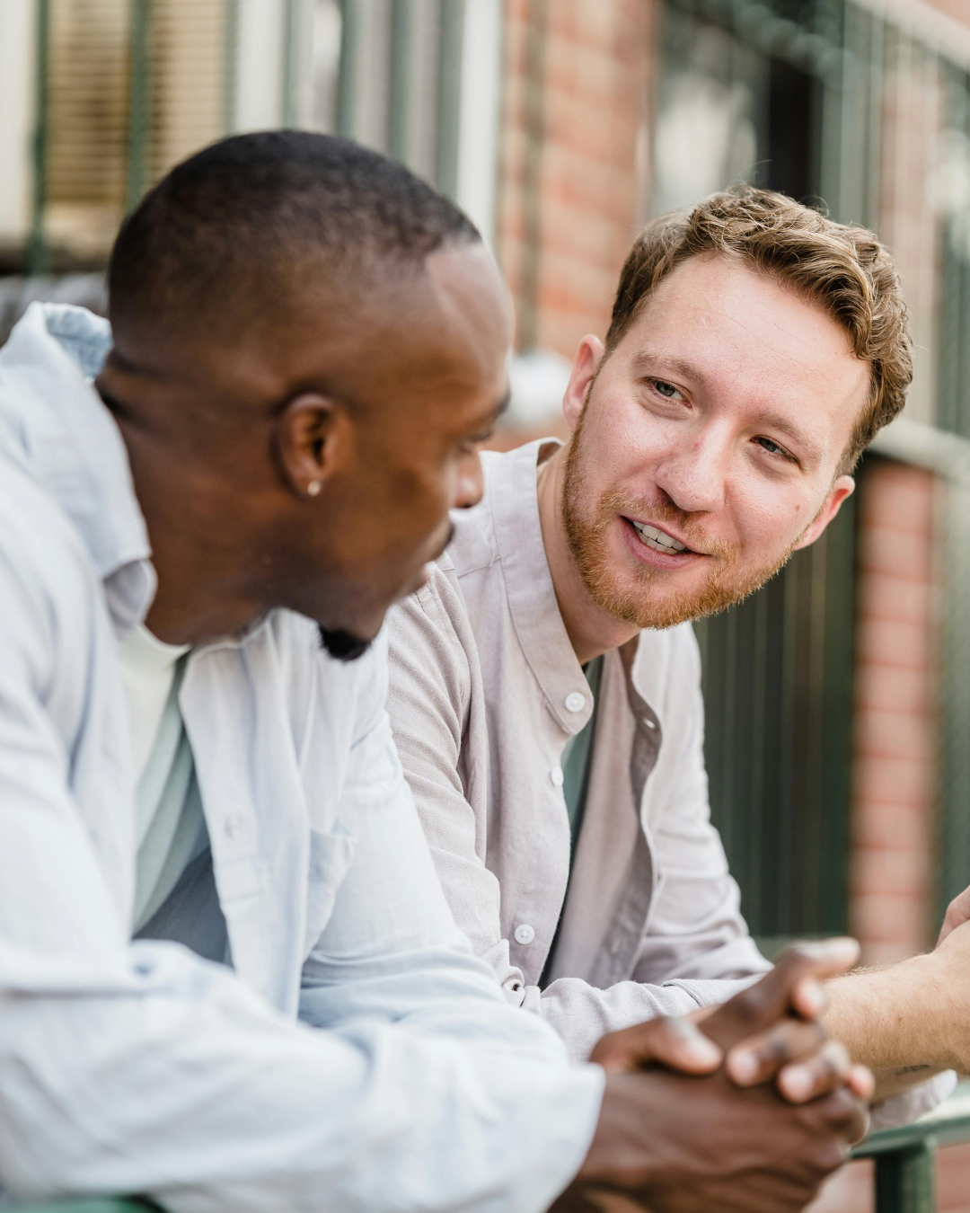 Two men talking outdoors about cardiovascular disease and lupus health management