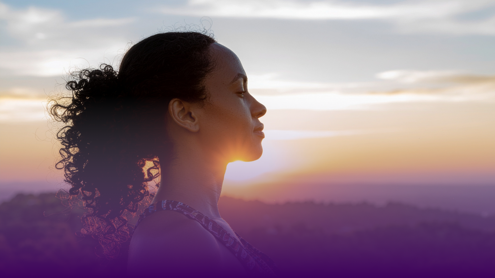 Woman with eyes closed facing the sunset, representing living with lupus and the invisible impact of chronic illness in Canada
