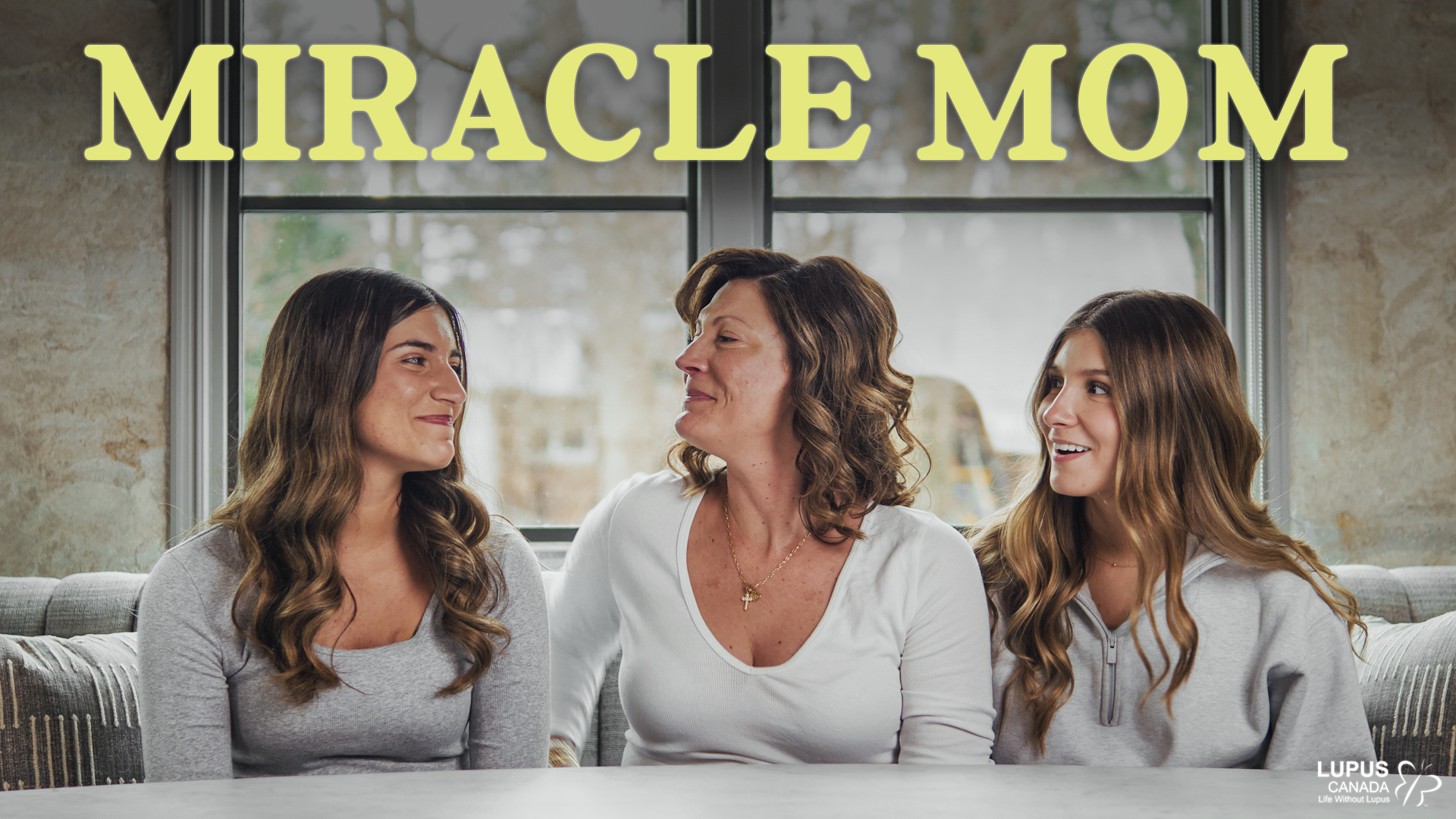 Diana Bozzo enlace l’une de ses filles dans une vidéo de Lupus Canada sur le lupus et la maternité, avec le texte « Miracle Moman » affiché sur la vignette.