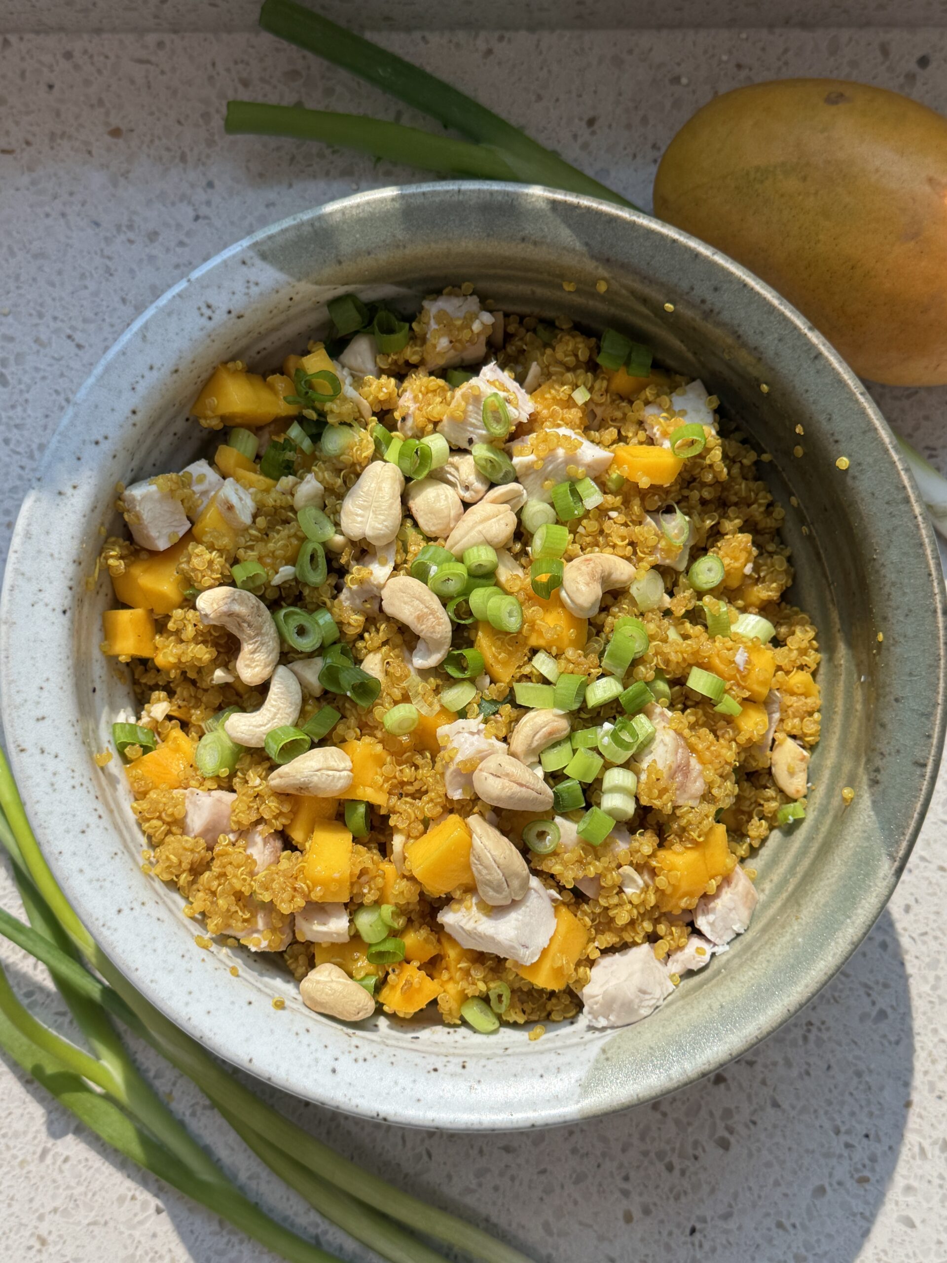 Curried chicken quinoa salad with mango, cashews and green onions